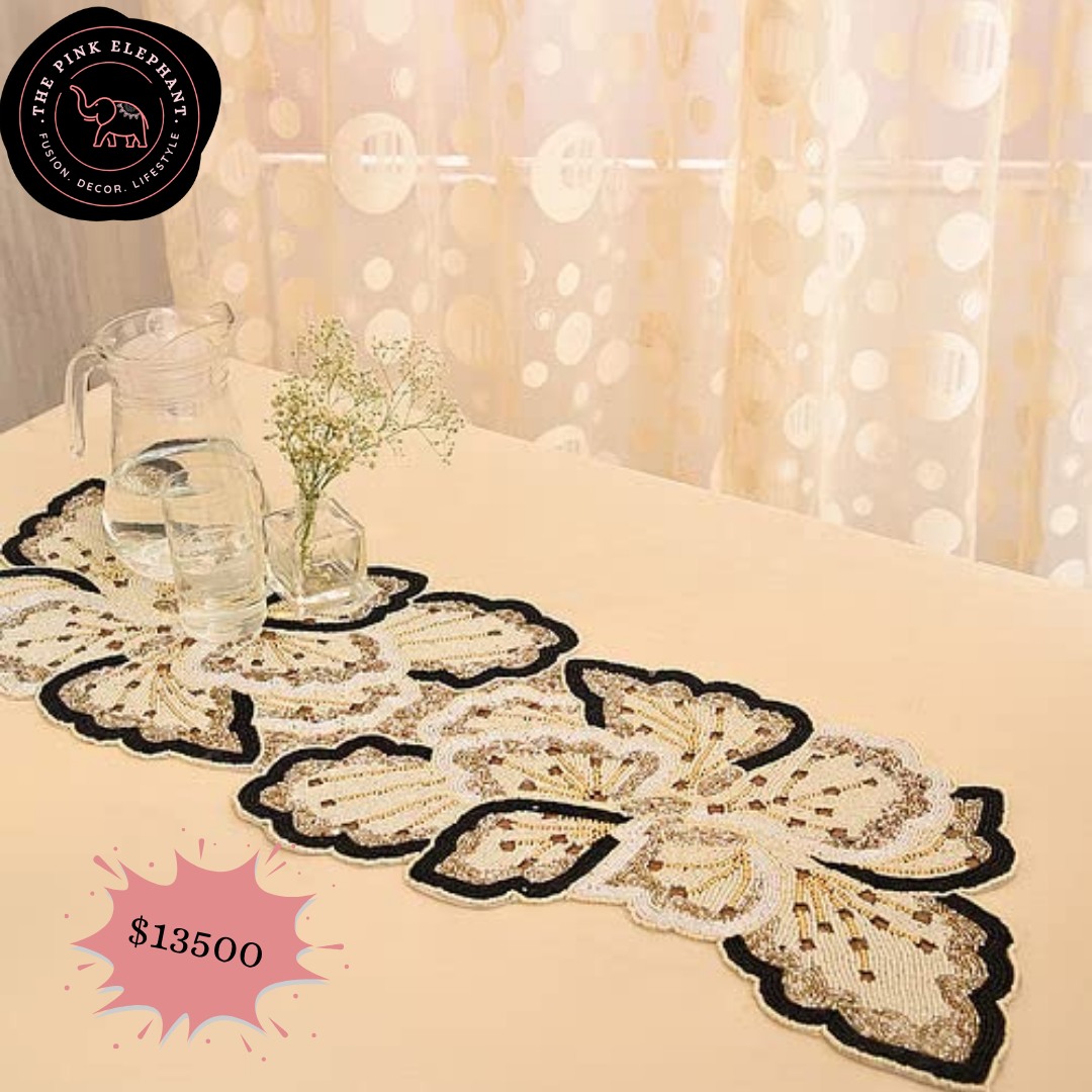 Decorative table runner with intricate patterns on a table with a blurred background